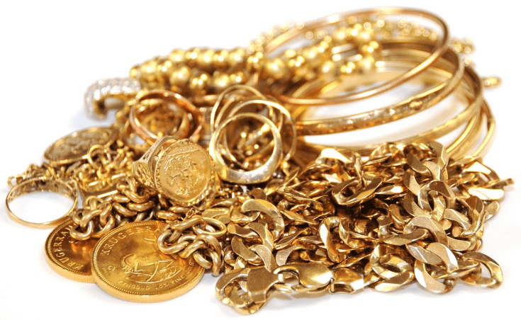 Pile of gold jewelry including bangles, rings, coins, and chains for pawn at Ideal Jewelry and Loan