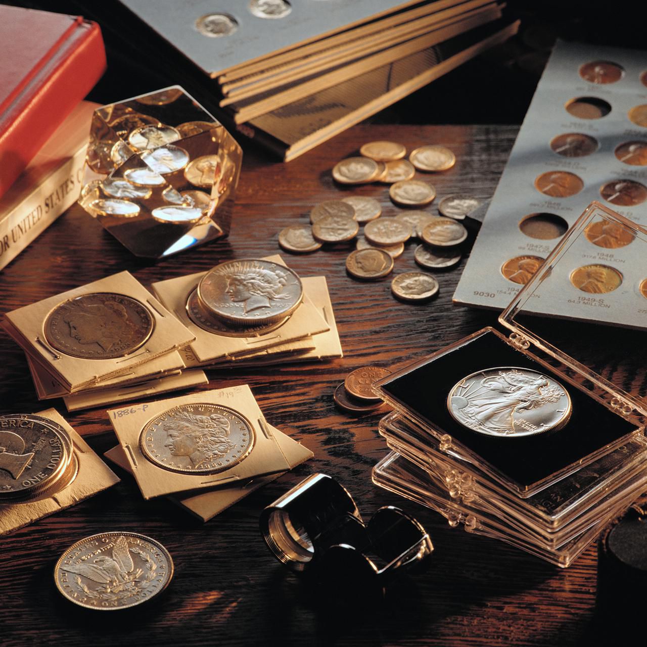 Vintage and collectible coins in protective cases and folders at Ideal Jewelry and Loan pawn shop in Brockton, MA.