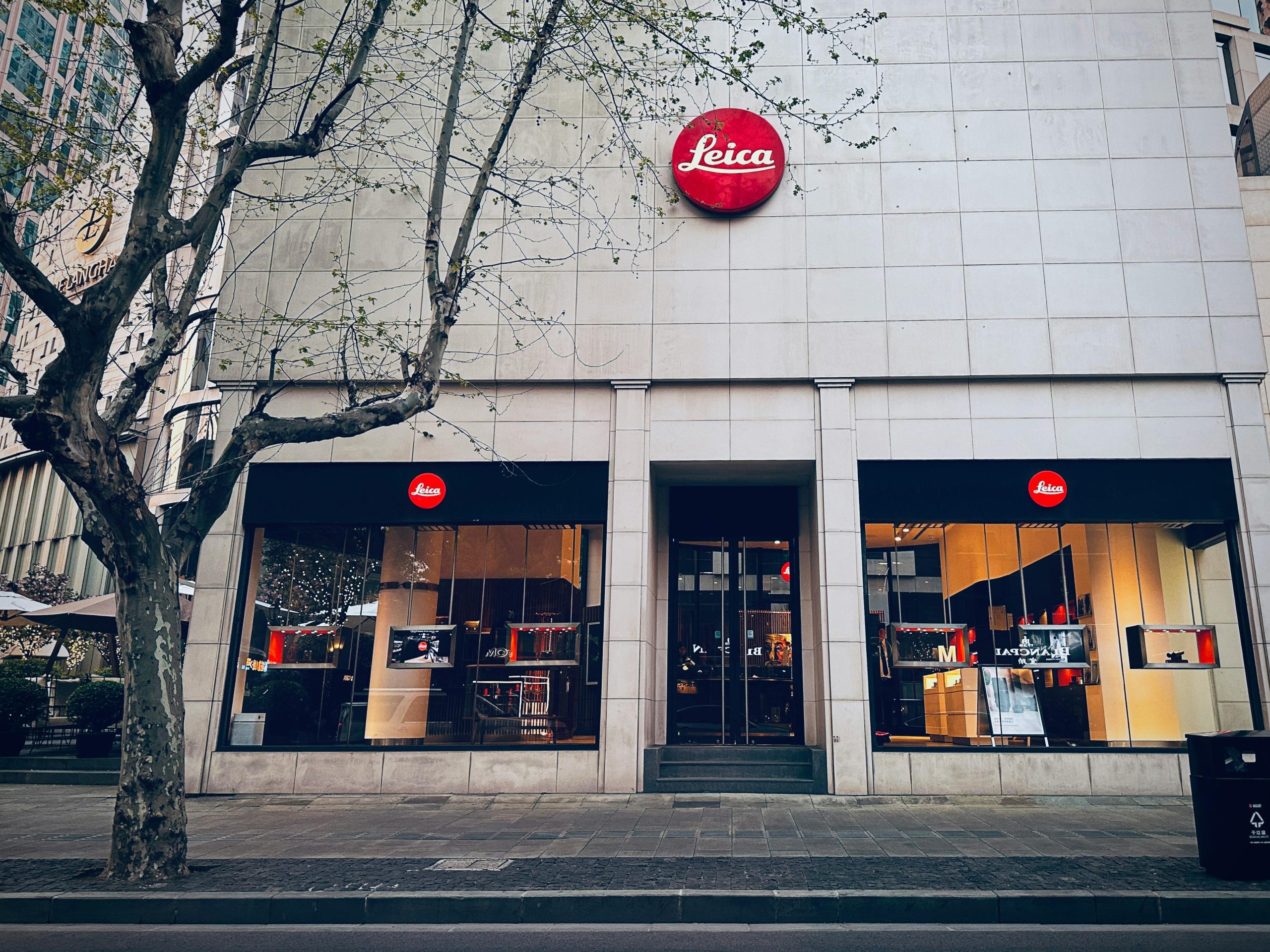 Leica storefront building with red signage.