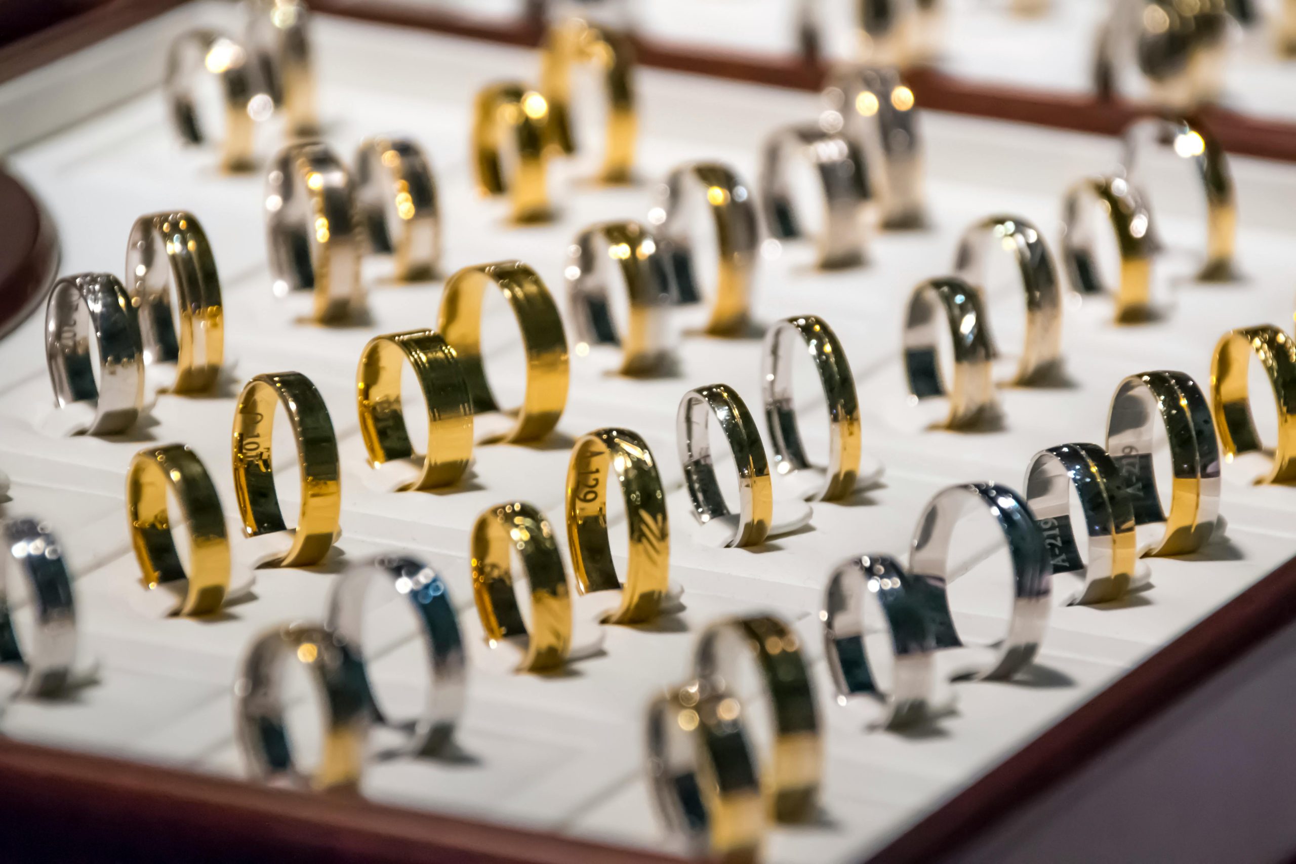 Display of gold and silver rings neatly arranged in a jewelry case at a pawn shop