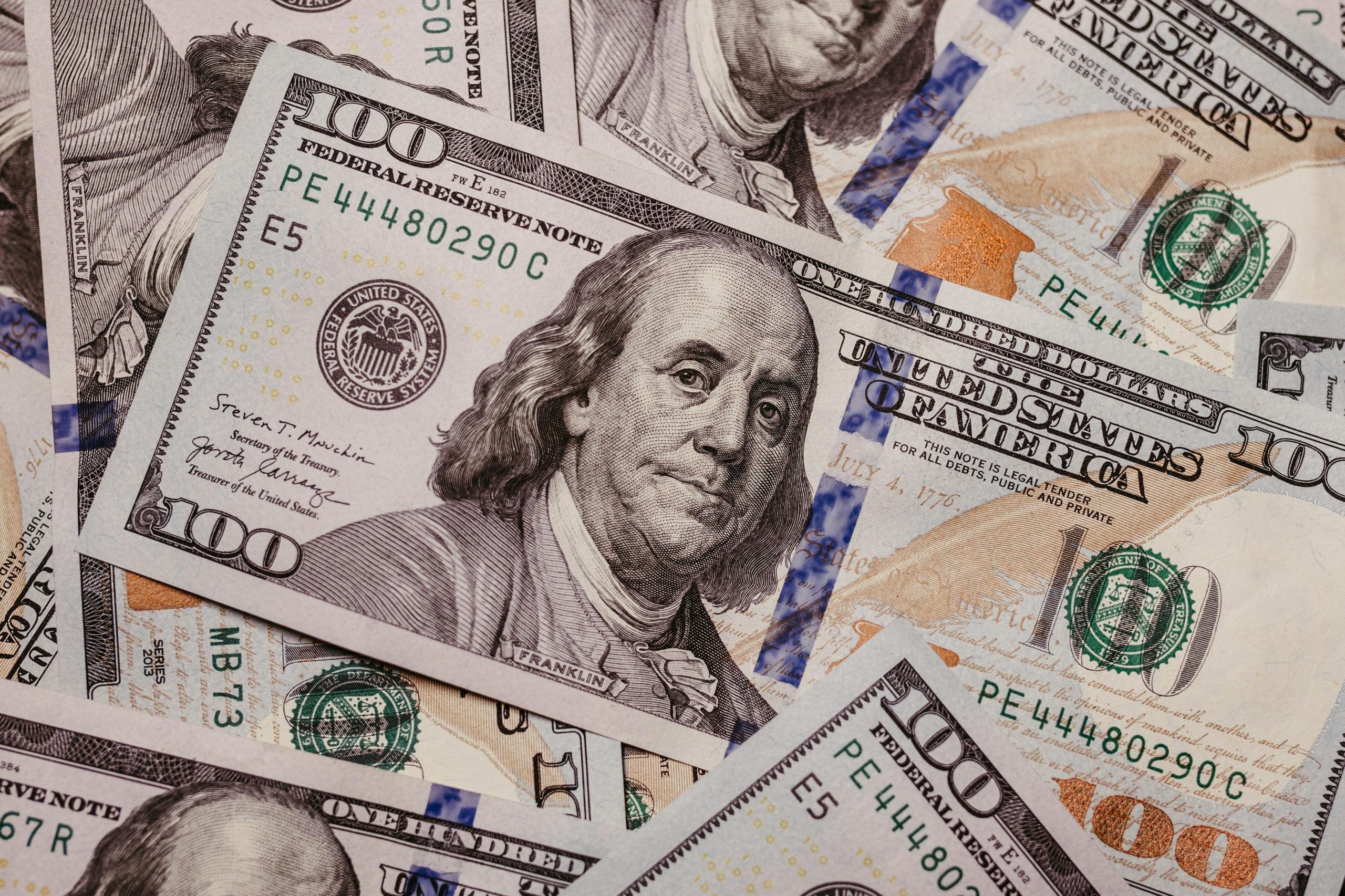 Stack of U.S. hundred-dollar bills symbolizing fast cash options at Pawn Shops