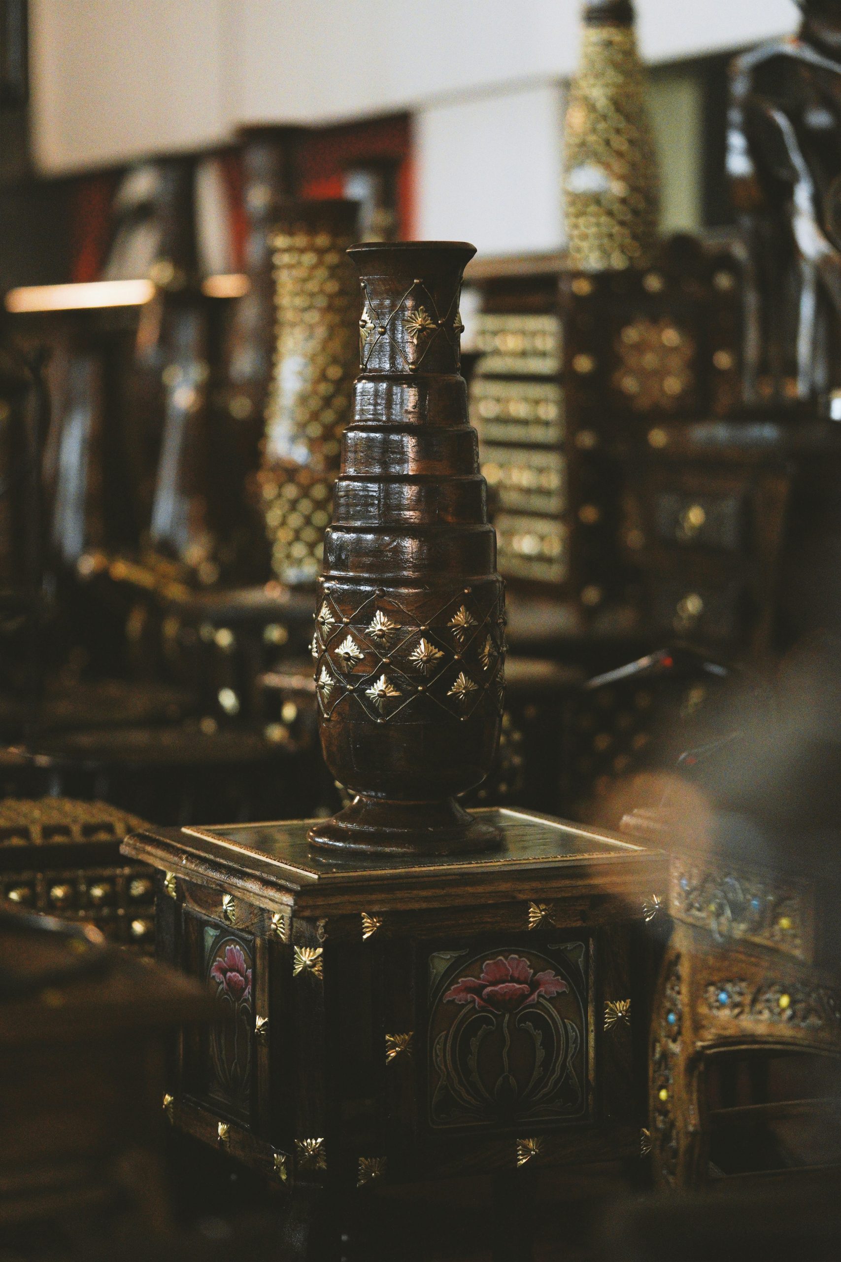 Ornate wooden luxury collectibles and furniture on display in a pawn shop