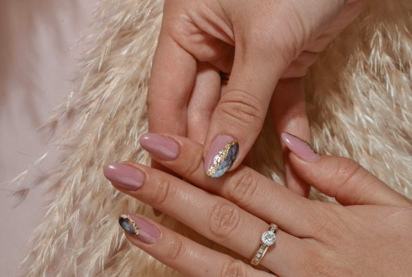 Woman's hand with elegant nail art wearing a diamond ring