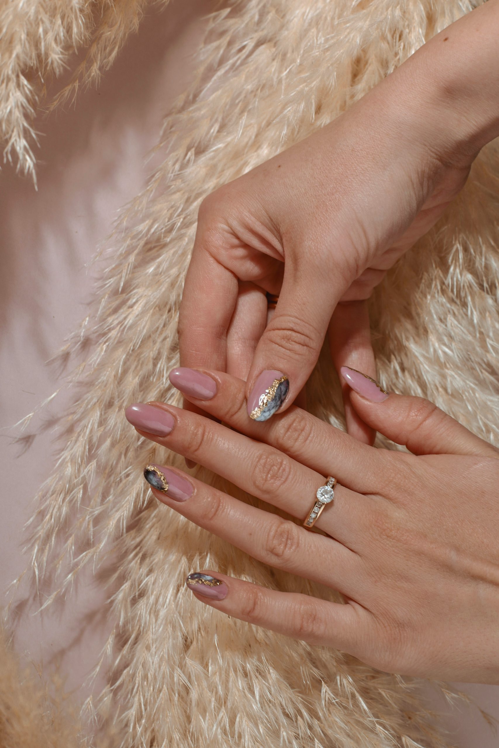 Woman's hand with elegant nail art wearing a diamond ring