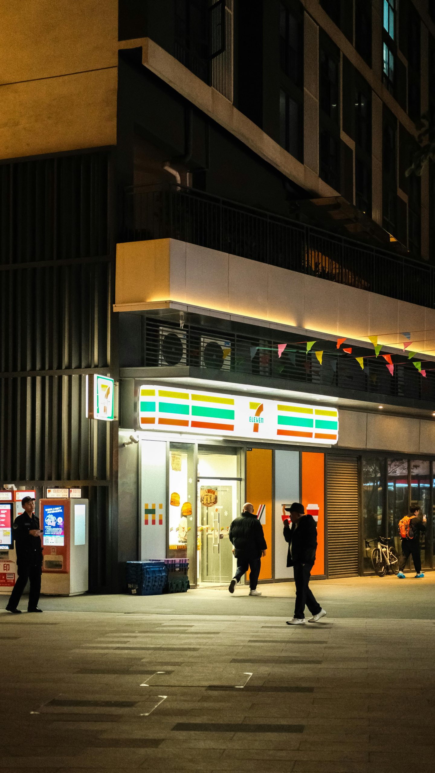 People walking near a brightly lit storefront at night, often confused with pawn shops due to common myths